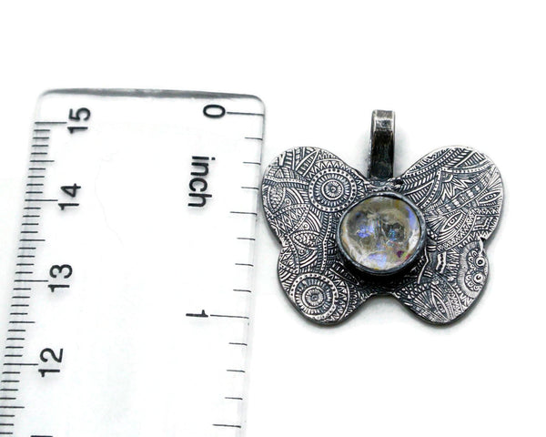 Silver custom spiritual butterfly pendant shown with ruler for sizing