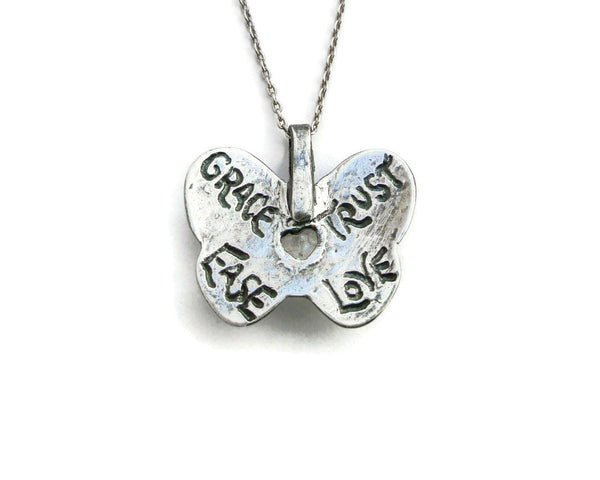 Back view of custom handmade silver butterfly pendant with personalized words of inspiration engraved on back